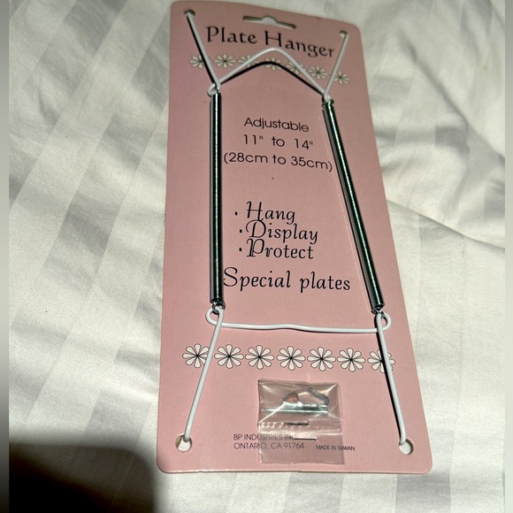 A set of 12 plate hangers.  Brand new. Adjustable 11 to 14 inches - Picture 1 of 3